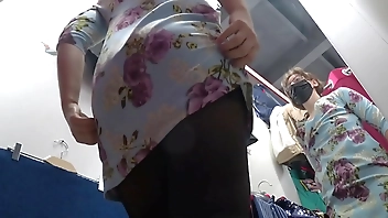 A hidden camera in a fitting room spies on a girl with a gorgeous ass and beautiful legs in pantyhose. Then a voyeur peeks under her skirt in a public store. Amateur foot fetish.