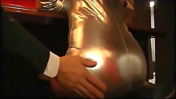 girl in shiny outfit pegging business man