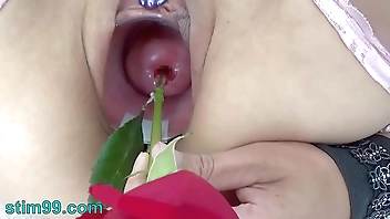 Extreme female inserting nettles into cervix and rod flowers